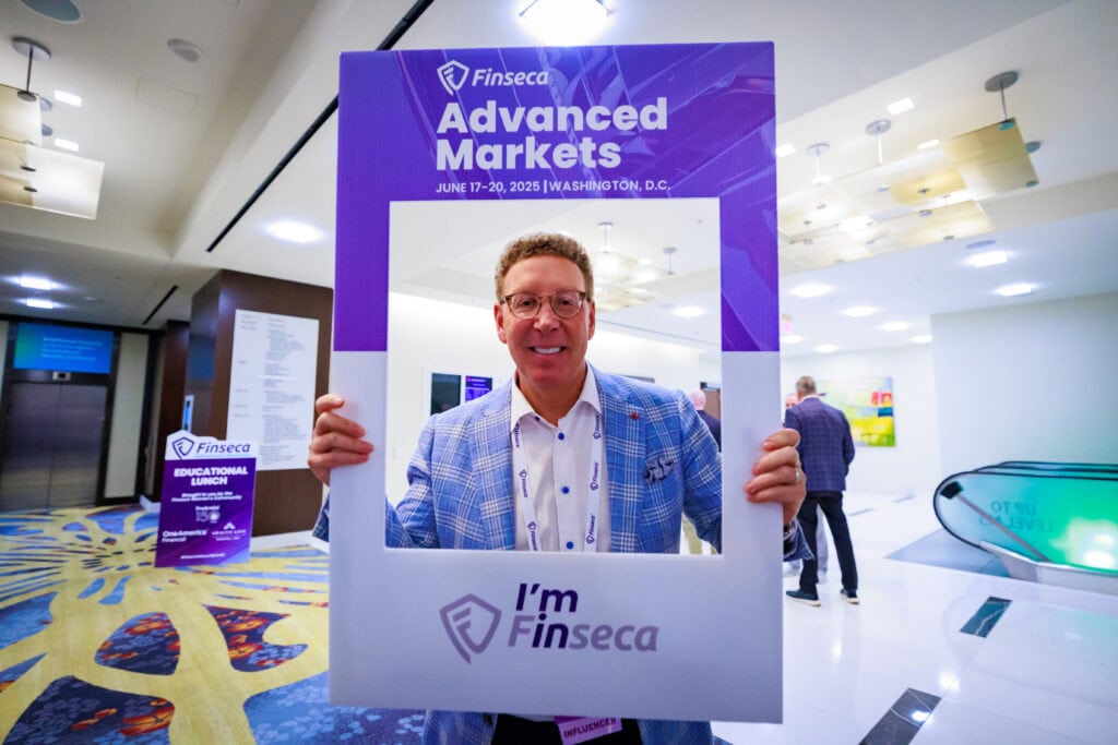 Harris at Finseca Advanced Markets holding an "I'm in sign"